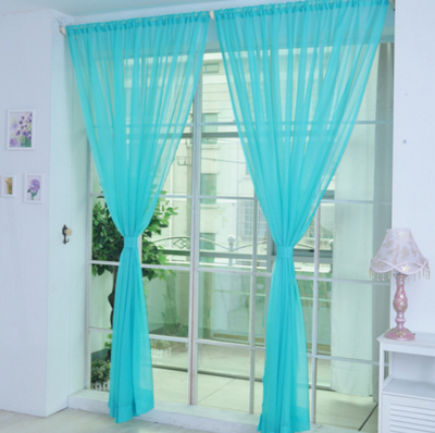 Close-up of a solid red sheer tulle curtain hanging in front of a window, allowing light to filter through. - Image 17