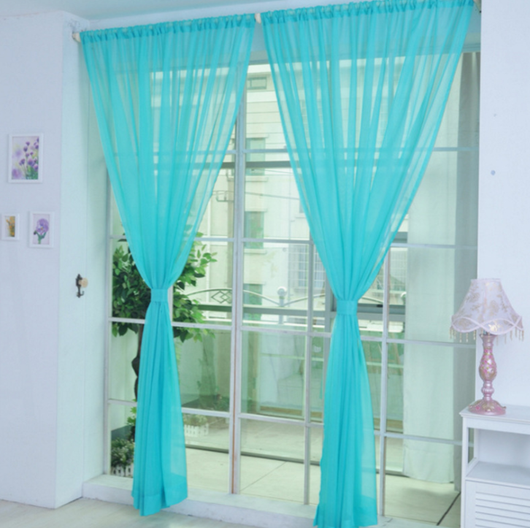 Close-up of a solid red sheer tulle curtain hanging in front of a window, allowing light to filter through. - Image 17
