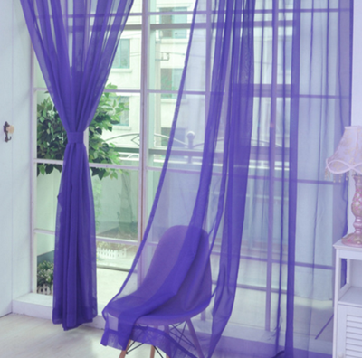 Close-up of a solid red sheer tulle curtain hanging in front of a window, allowing light to filter through. - Image 18