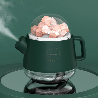 Pink kettle-shaped mini USB humidifier with a clear dome top filled with pink salt crystals, emitting mist. - Image 9