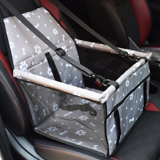 Light grey pet car booster seat with black mesh sides and adjustable straps, installed on a black and red car seat. - Image 13