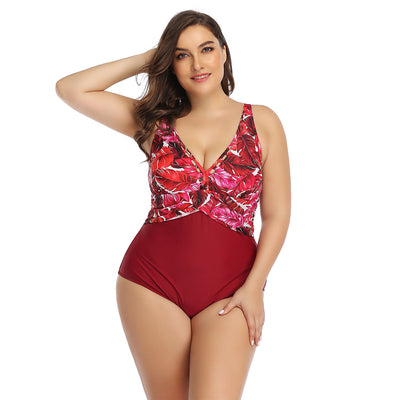 Plus size one-piece swimsuit with a red tropical leaf print top and solid dark red bottom, featuring a crossover chest. - Image 16
