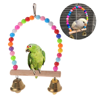 Colorful wooden bird swing with an arched top made of rainbow beads, a natural wood perch, and two small bells.
