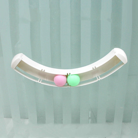 White curved track cat toy with green and pink balls, mounted on a blue wall, with two cats playing. - Image 5