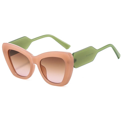 Pink cat-eye sunglasses with green temples and brown to pink gradient lenses on a white background. - Image 19