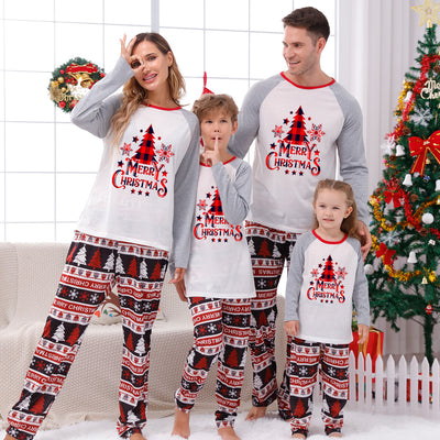 Family of four wearing matching Christmas pajamas with 'MERRY Christmas' text, leopard print, and plaid trees. - Image 4