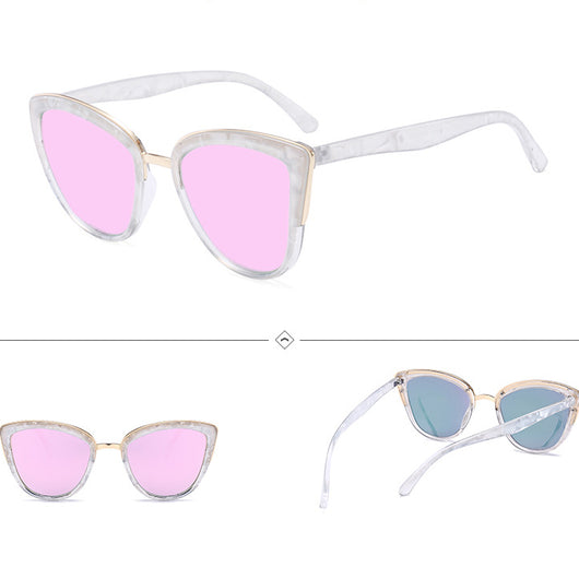 Female cat-eye sunglasses with clear marbled plastic frames, pink mirrored lenses, and gold-tone accents.