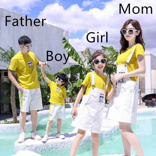 Family of three in matching yellow t-shirts and white outfits by a pool. Father and son wear shorts, mother and daughter wear overall dresses. - Image 12