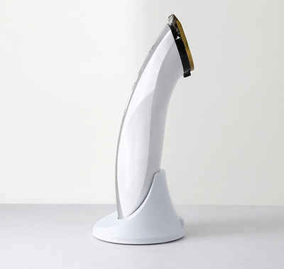 White and silver Kemei KM-1830 electric hair clipper with a charging base on a light background. - Image 4