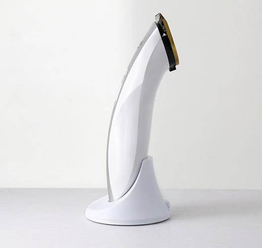 White and silver Kemei KM-1830 electric hair clipper with a charging base on a light background. - Image 4