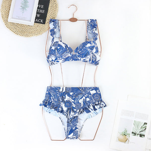 Purple and white floral high-waisted bikini with ruffled straps and push-up bandeau top.
