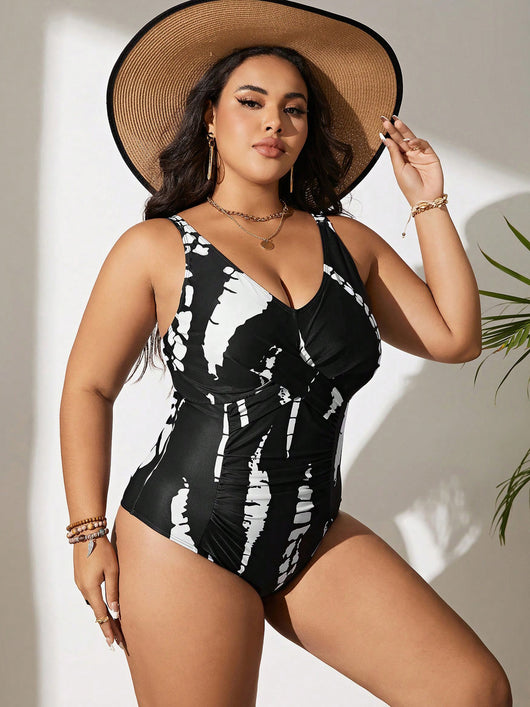 Plus size black and white tie-dye one-piece swimsuit with a V-neck and ruched detailing, worn by a model. - Image 7