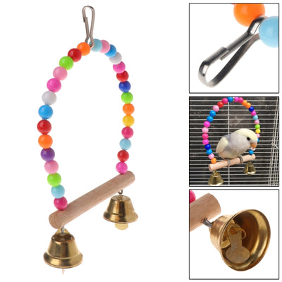 Colorful wooden bird swing with an arched top made of rainbow beads, a natural wood perch, and two small bells. - Image 5