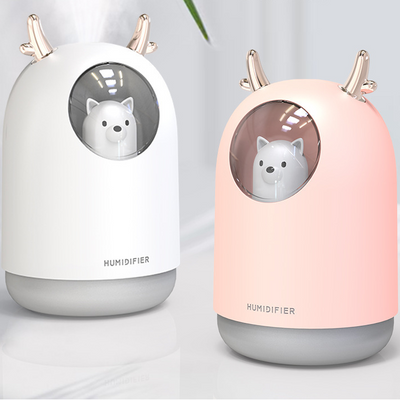 White and pink cute bear mini humidifiers with gold deer antlers, emitting a fine mist.