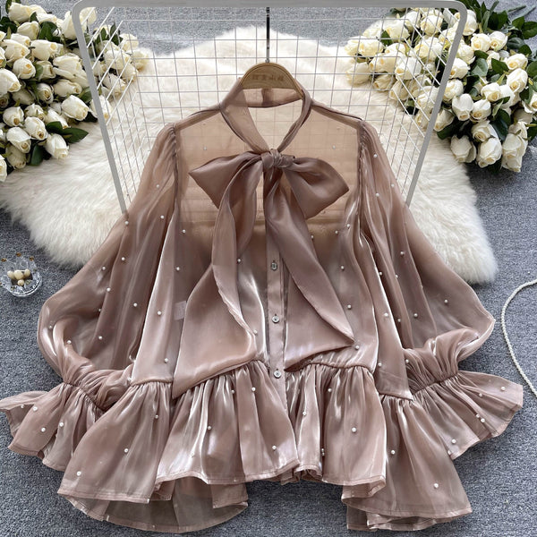 Blusa Elegante con Mangas Acampanadas y Detalle de Moño en Perlas