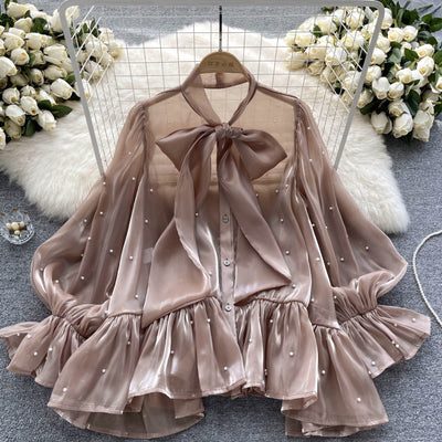 Blusa Elegante con Mangas Acampanadas y Detalle de Moño en Perlas