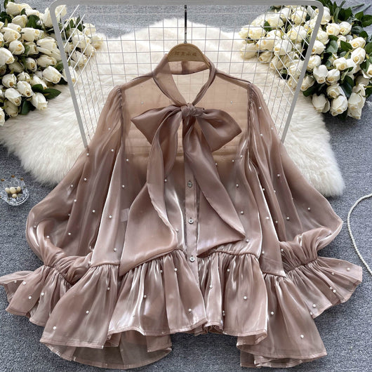 Blusa Elegante con Mangas Acampanadas y Detalle de Moño en Perlas