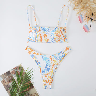 White ribbed two-piece swimsuit with pink and blue paisley floral print, bandeau top, and high-cut bottoms. - Image 4