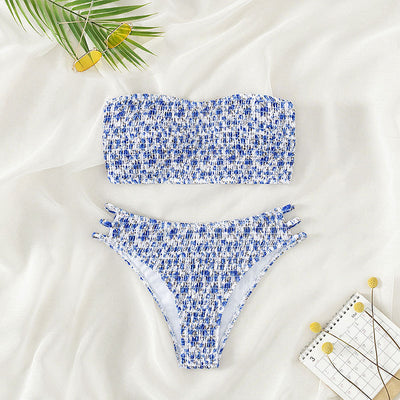 Floral smocked strapless bandeau bikini with high-cut bottoms featuring side straps, in white, teal, and red.