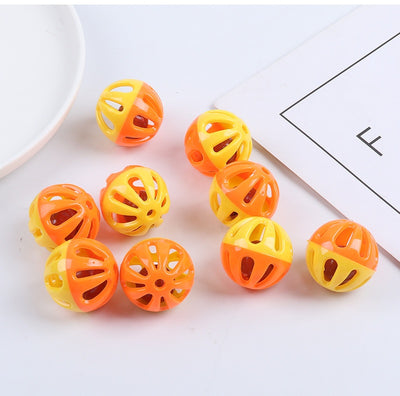 Five colorful plastic pet bell balls in red, yellow/orange, lime green, and hot pink, with hollow designs. - Image 13