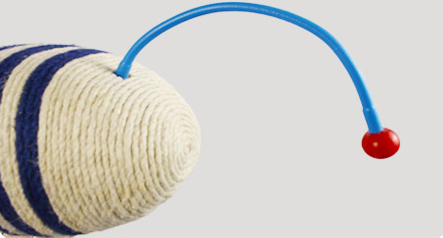 Blue and white striped fish-shaped sisal cat scratching post with a purple base, next to a black and white cat. - Image 9