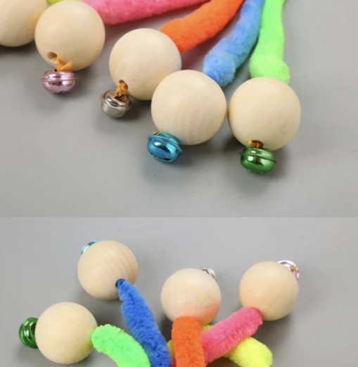 Orange plush cat toy with a wooden ball and a small golden bell, designed for cats to play and nibble. - Image 6