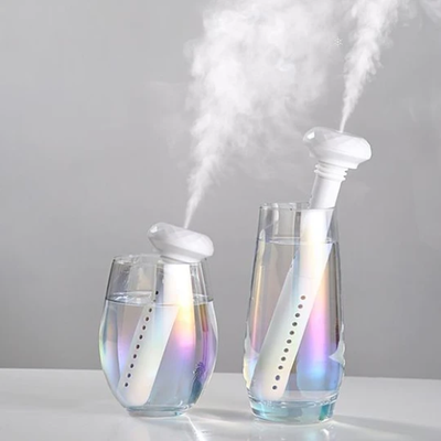 White portable USB humidifier with a columnar body and faceted top, featuring a USB port and control button. - Image 10