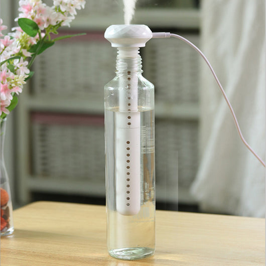 White portable USB humidifier with a columnar body and faceted top, featuring a USB port and control button. - Image 3