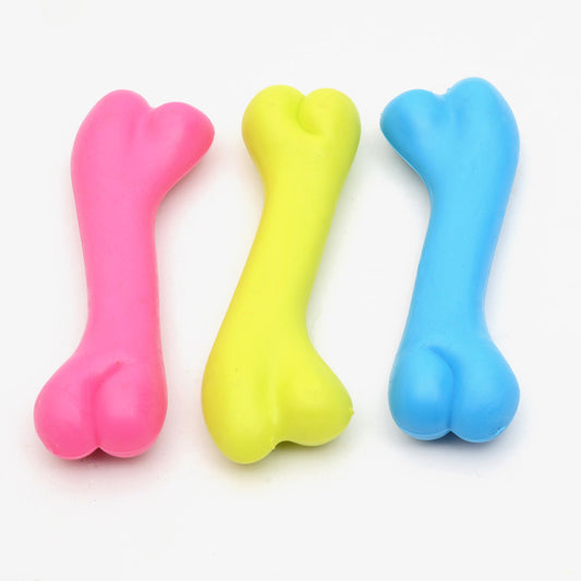 Three colorful rubber bone-shaped chew toys for puppies in pink, yellow, and blue on a white background.