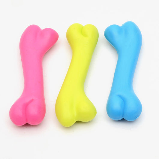 Three colorful rubber bone-shaped chew toys for puppies in pink, yellow, and blue on a white background.