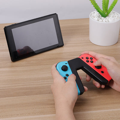 V-shaped charging grip for Nintendo Switch Joy-Cons, featuring a black body with blue and red slots. - Image 9