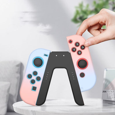 V-shaped charging grip for Nintendo Switch Joy-Cons, featuring a black body with blue and red slots.