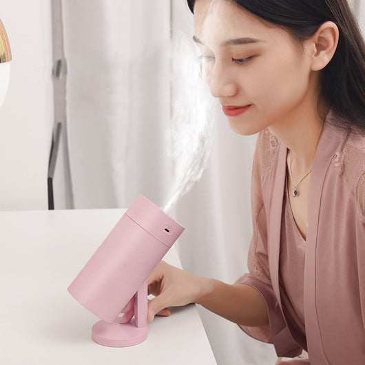 White cylindrical USB desktop humidifier with a mist outlet and a circular control button on top. - Image 3