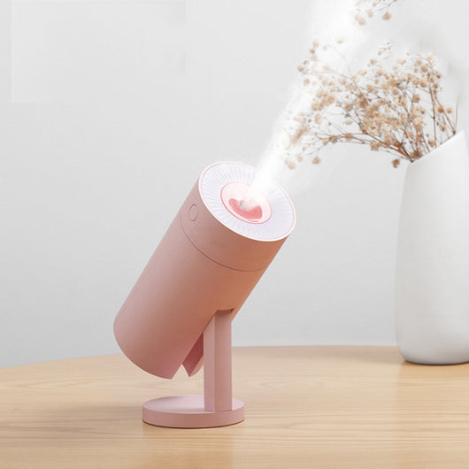 White cylindrical USB desktop humidifier with a mist outlet and a circular control button on top.