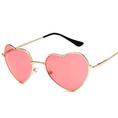 Gold frame heart-shaped sunglasses with transparent yellow lenses and black earpiece tips.