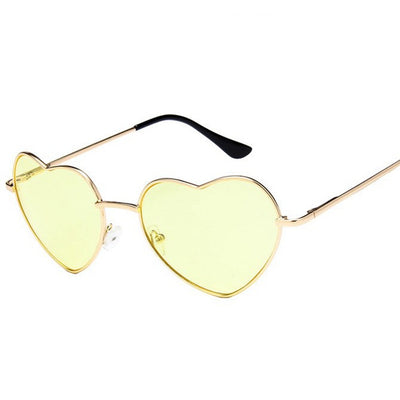 Gold frame heart-shaped sunglasses with transparent yellow lenses and black earpiece tips. - Image 3