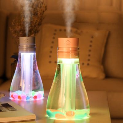 Wishing bottle humidifier with a clear body, white top, and colorful decorative stones at the bottom. - Image 8