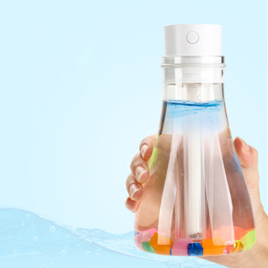 Wishing bottle humidifier with a clear body, white top, and colorful decorative stones at the bottom. - Image 10