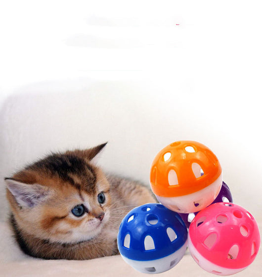 Five hollow green and yellow plastic cat toy balls with star-shaped cutouts scattered on a white surface. - Image 6