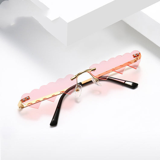 Women's rimless sunglasses with unique heart-shaped black lenses and gold-colored metal temples. - Image 13