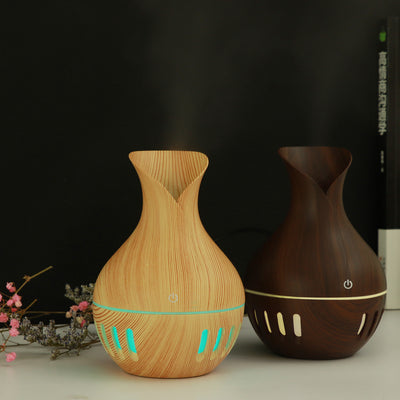 Dark brown wood grain mini USB humidifier with a vase-like shape and a green LED light band and slots. - Image 7