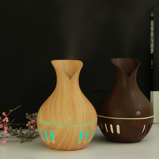 Dark brown wood grain mini USB humidifier with a vase-like shape and a green LED light band and slots. - Image 7