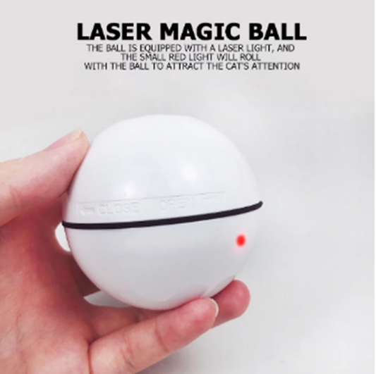 White automatic pet laser ball with a red LED light, held in a hand, designed to attract a cat's attention.