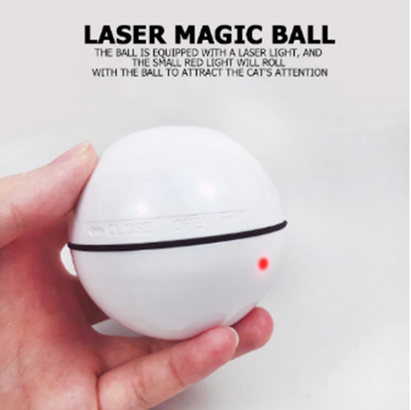 White automatic pet laser ball with a red LED light, held in a hand, designed to attract a cat's attention.