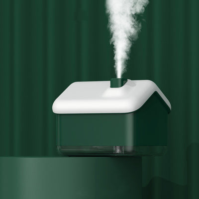 Pink and white house-shaped humidifier and essential oil diffuser with a clear base and a white power cord. - Image 9