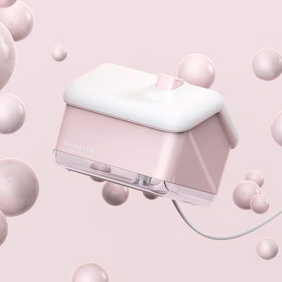 Pink and white house-shaped humidifier and essential oil diffuser with a clear base and a white power cord. - Image 13