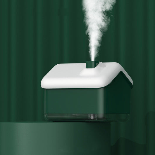 Pink and white house-shaped humidifier and essential oil diffuser with a clear base and a white power cord. - Image 2