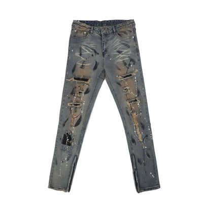 Jeans Rotos con Detalles de Tinta y Parches Desgastados - Image 11