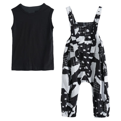 Girls' two-piece outfit with a black sleeveless top and black and white camouflage wide-leg suspender pants. - Image 7