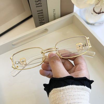 Black rectangular sunglasses with dark lenses and a thin metal frame, held by a hand against a light background. - Image 9
